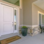 White front door with welcome mat on patio Glacier_Glass_Regina Glacier_Glass_Regina