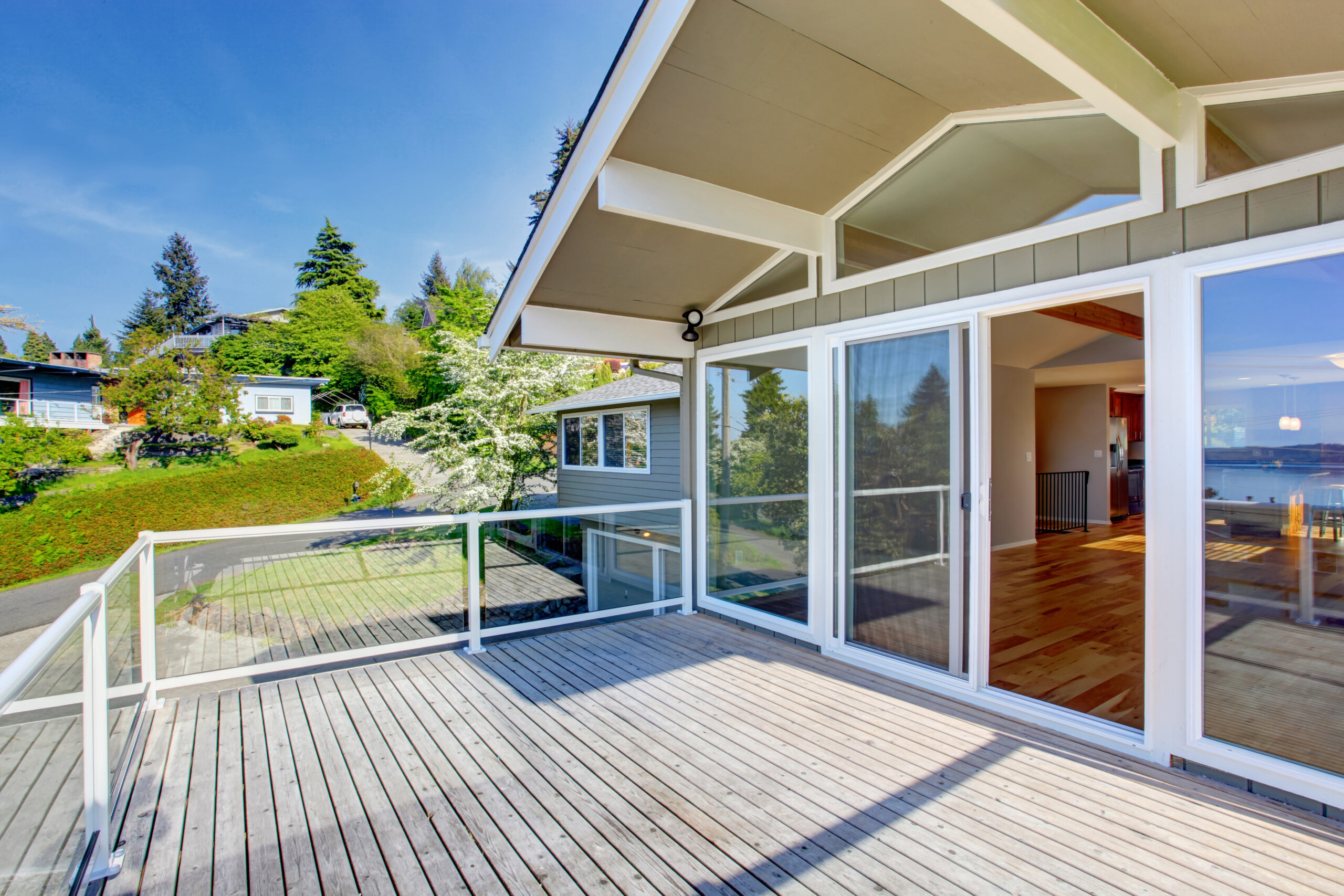 Balcony house exterior with glass railings and perfect view.