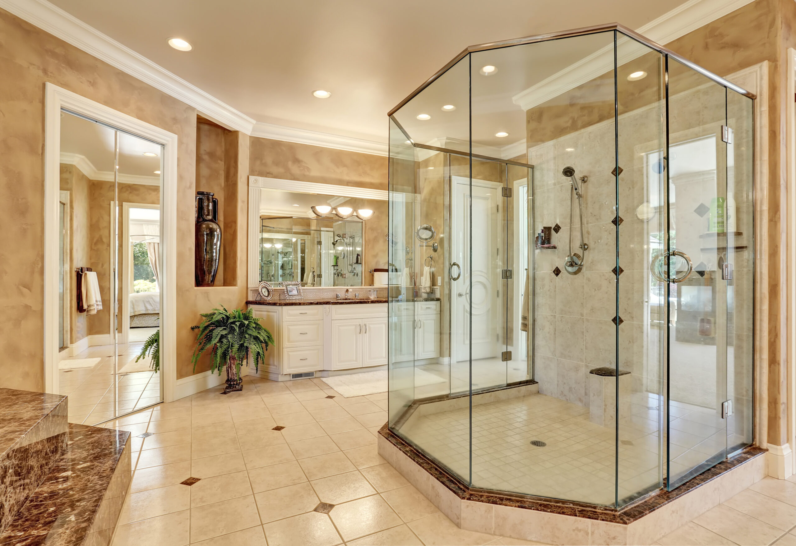 Beautiful luxury marble bathroom interior in beige color. Large glass walk in shower. Northwest, USA