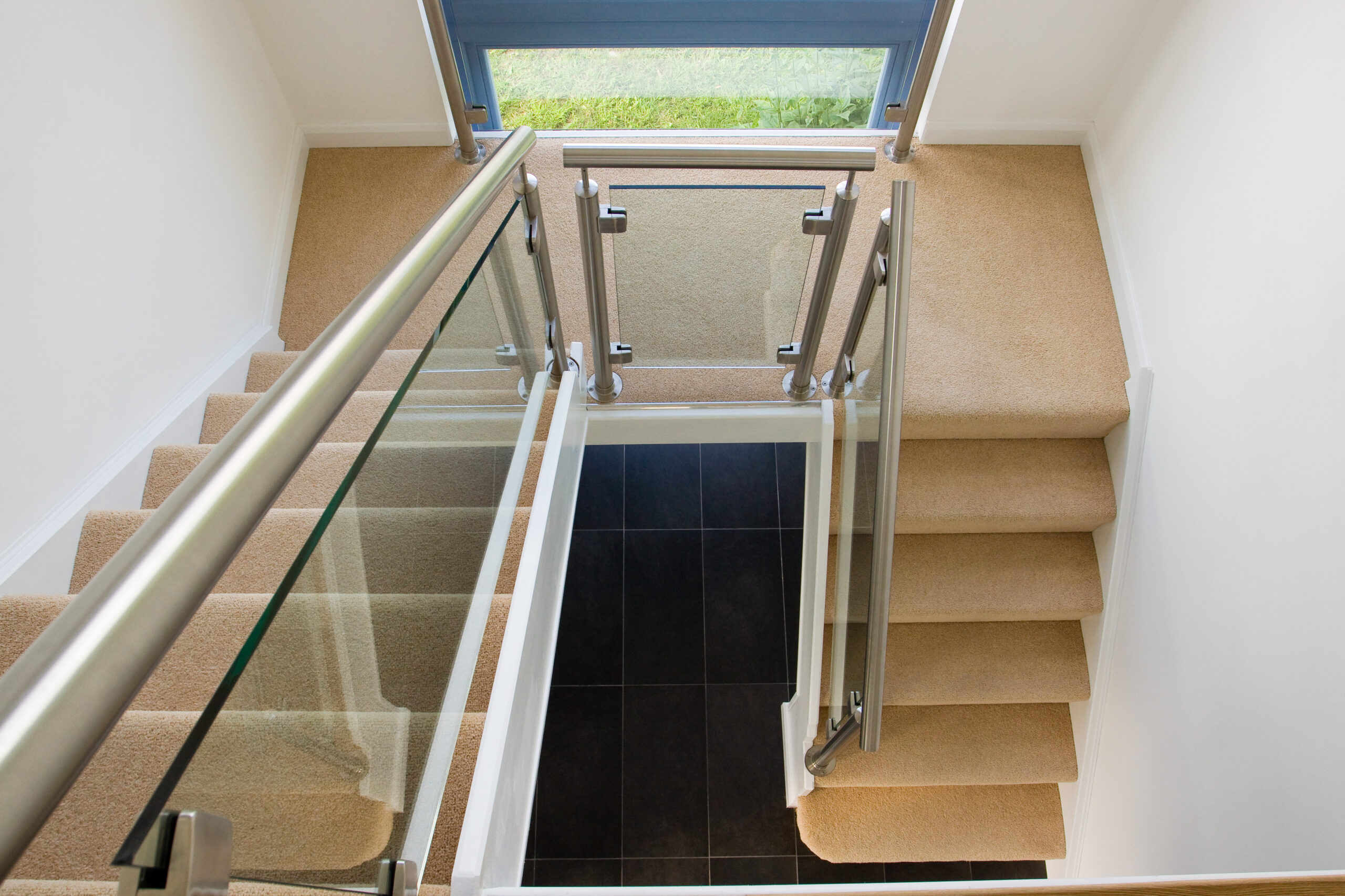 A modern staircase in a newly built property with countryside views