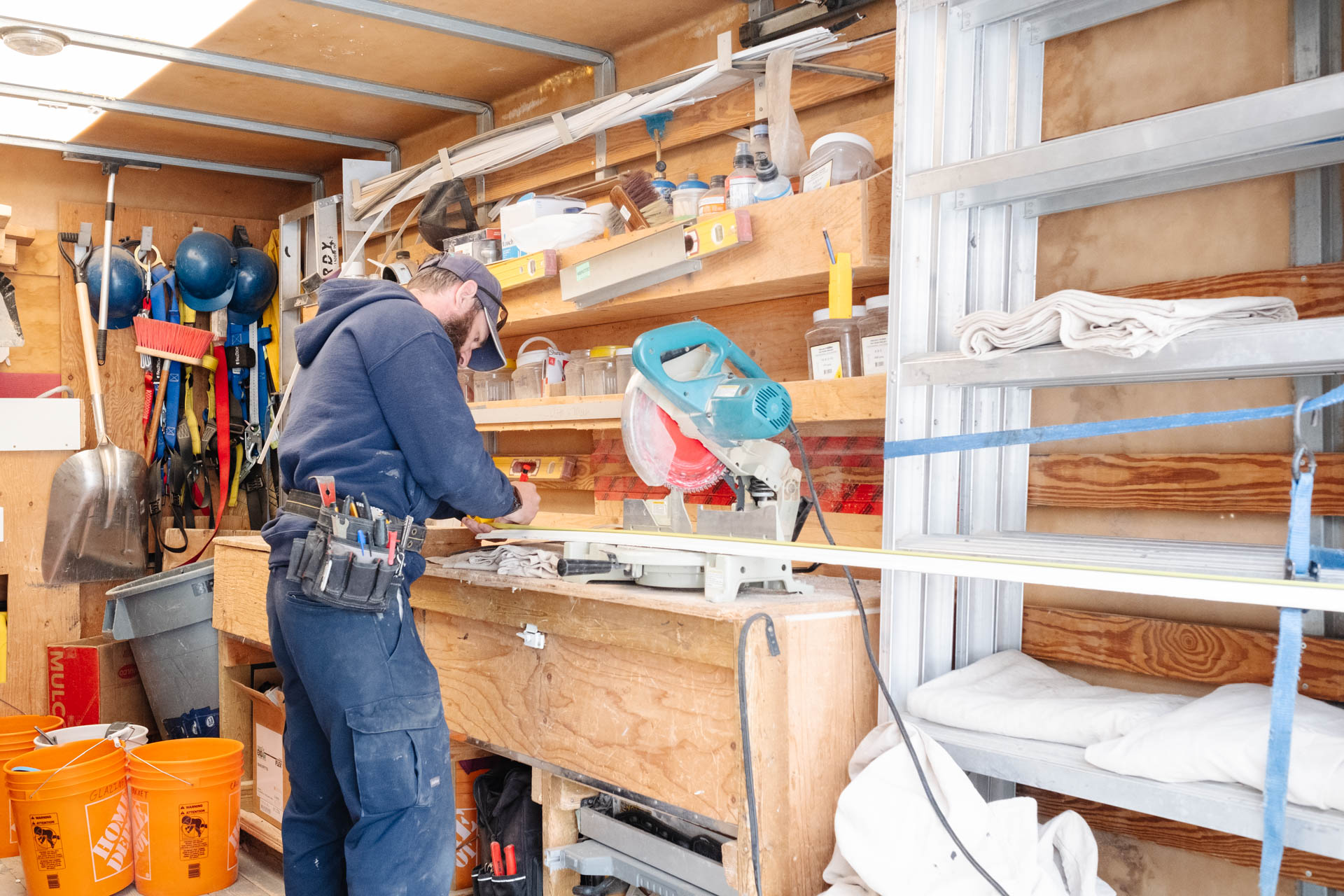 Glacier Glass technician preparing tools for a window replacement in the back of a branded work truck